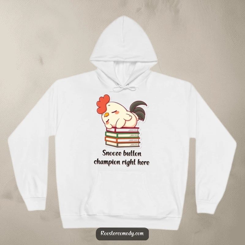 Funny hoodie showcasing a dozing rooster, fluffy tail, unintentionally toppling books, embodying cozy humor and silliness.